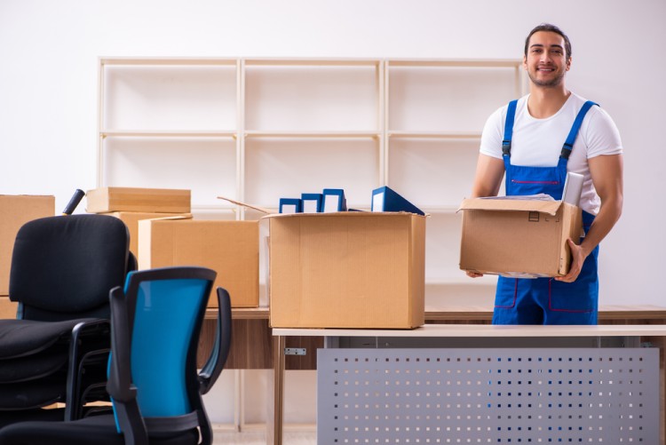 Office removalists working to pack office items in boxes