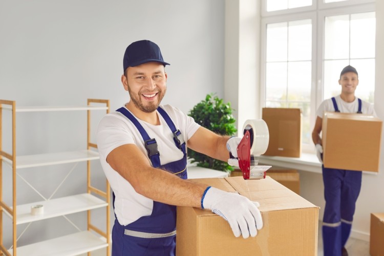 Office removalists working to pack office items in boxes