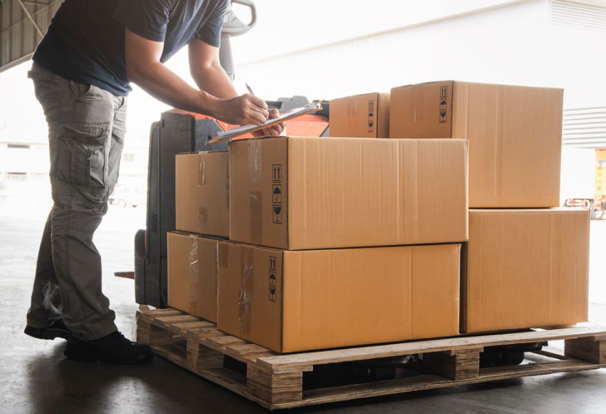 warehouse worker labelling the boxes